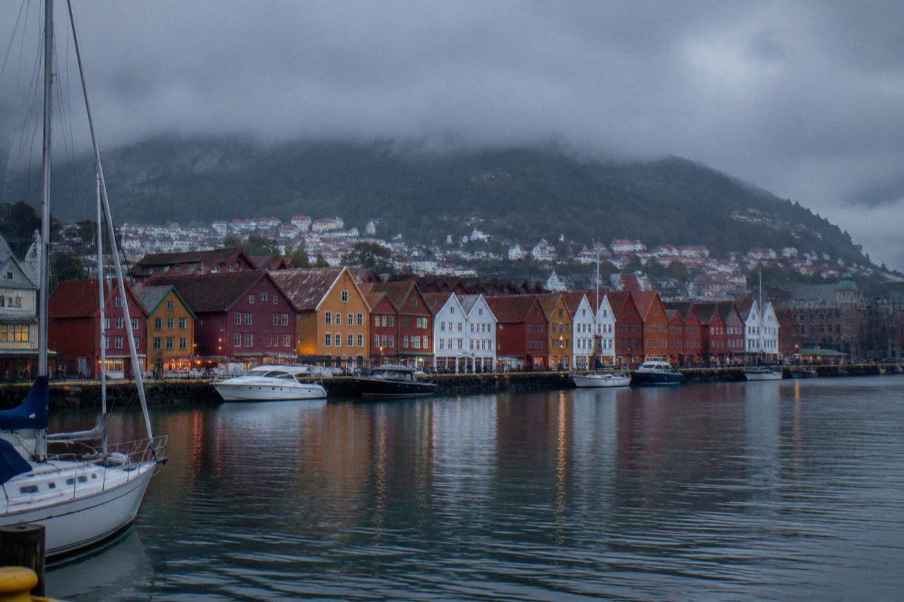 Colourful wooden Hanseatic houses along the wharf in Bergen under an overcast sky