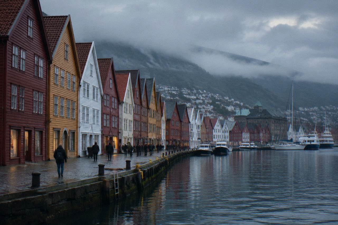 Bryggen wharf in Bergen with tightly packed wooden houses in red, ochre and white along the harbour front