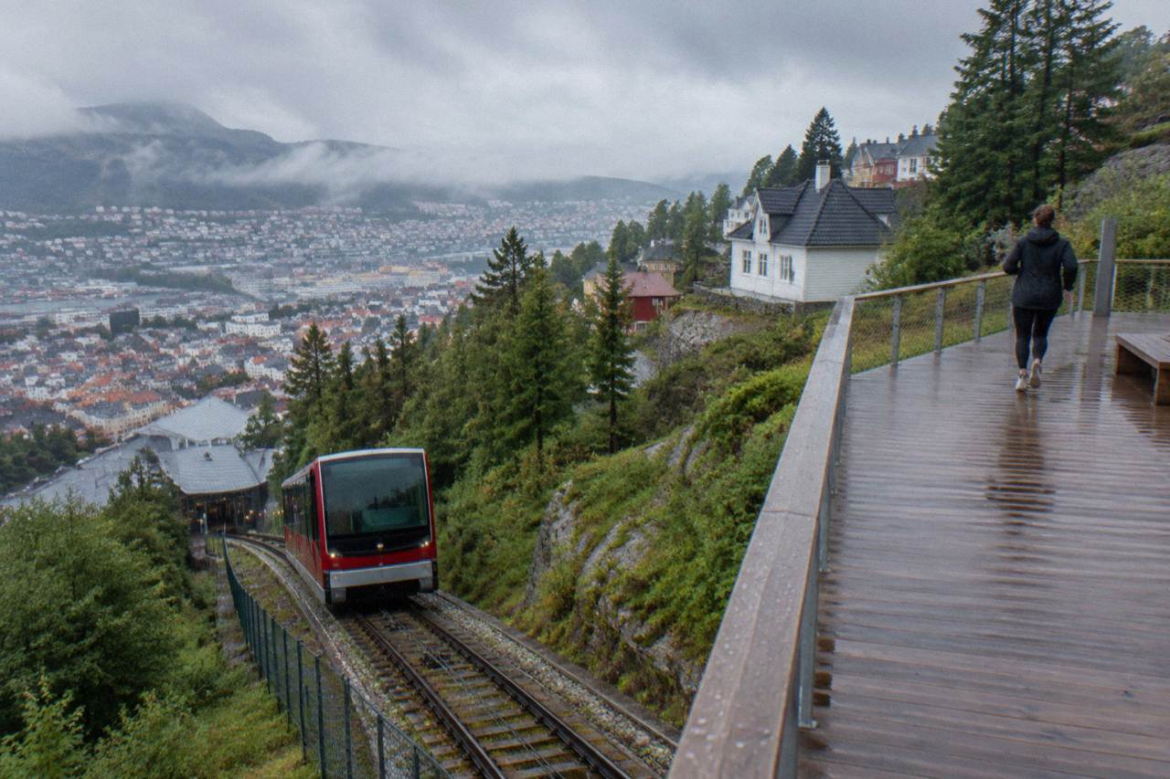 The Fløibanen funicular station at the base of Mount Fløyen in Bergen, with wooden houses on the hillside above