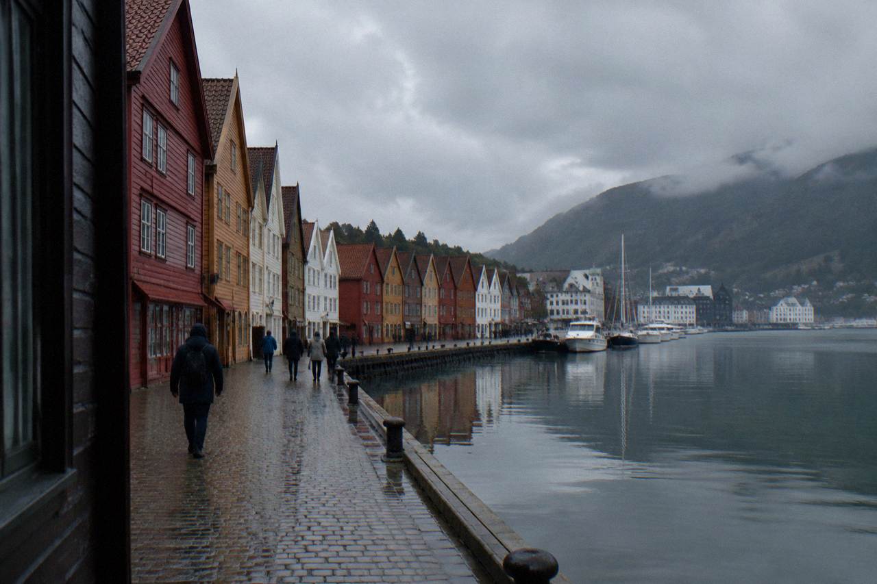 Wooden merchant houses along the historic Bryggen wharf in Bergen reflected in the harbour water