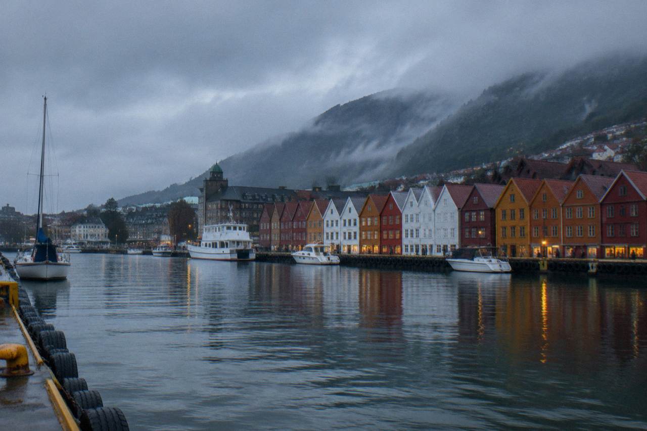 Colorful wooden houses along the waterfront in Bergen on an overcast day