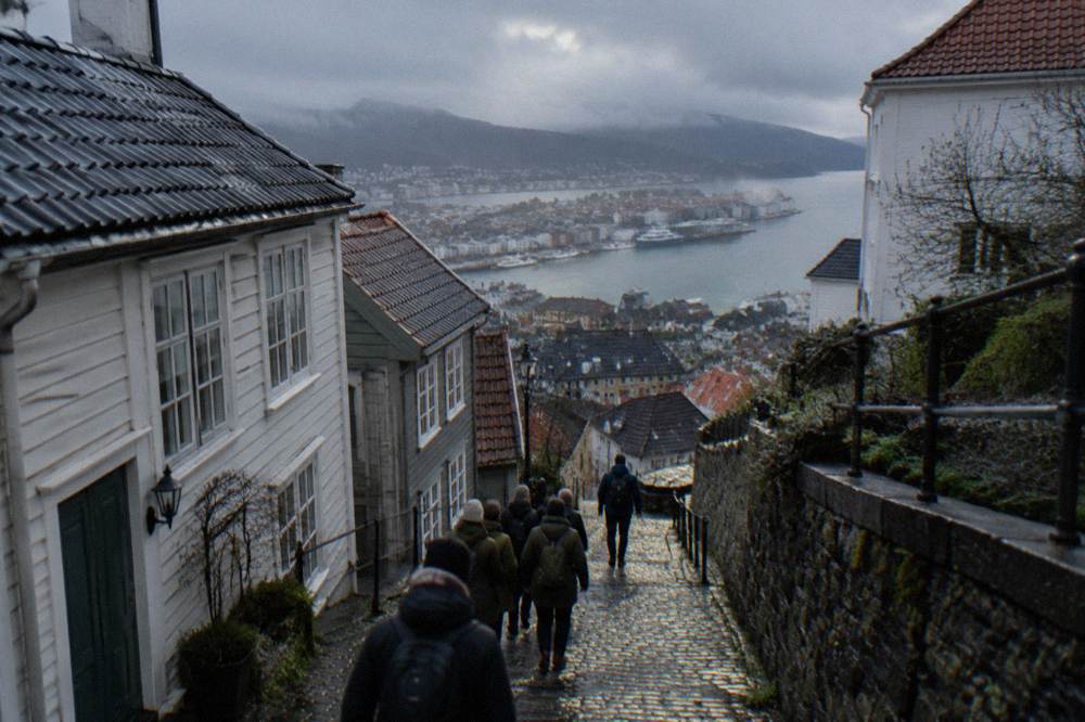 A small group following a guide along a narrow street in central Bergen