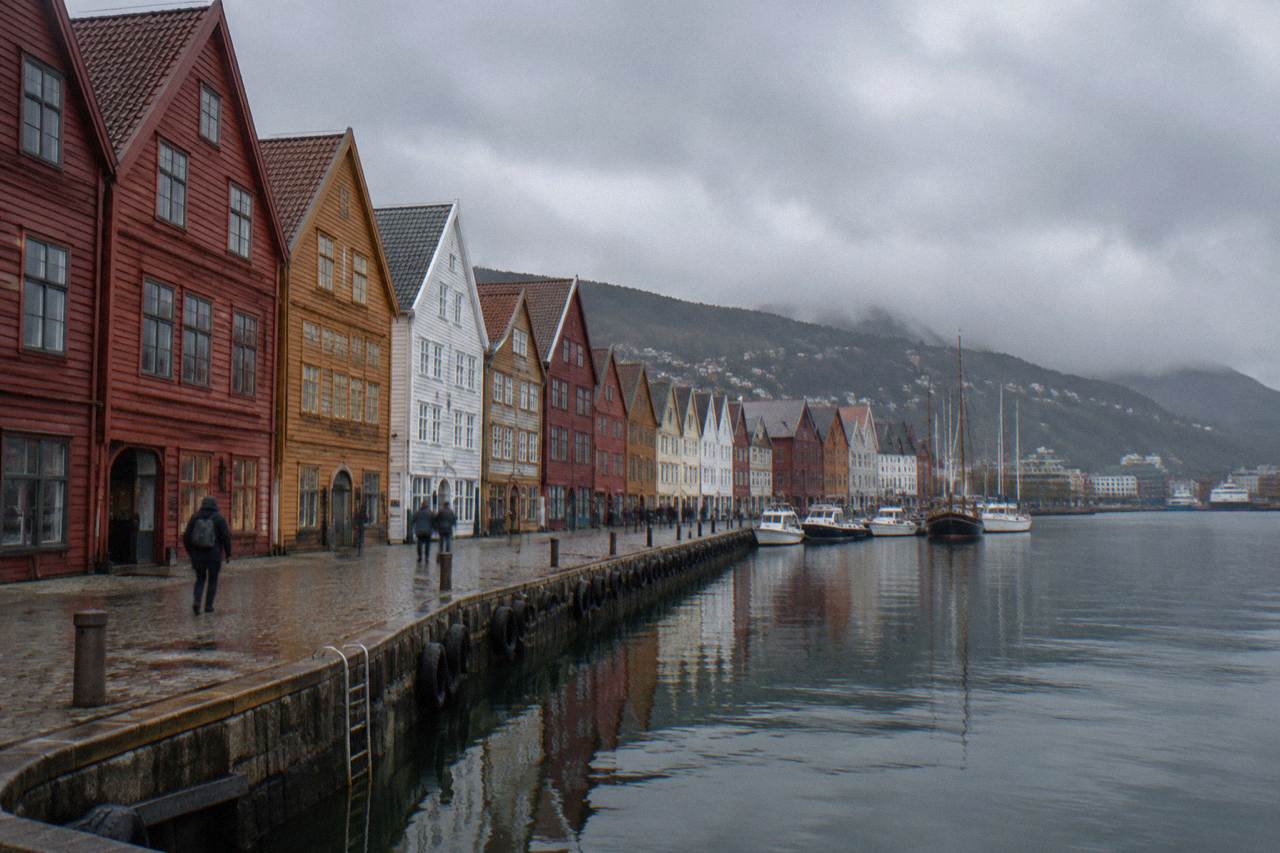 Colourful wooden houses on the Bryggen wharf in Bergen reflected in the harbour water