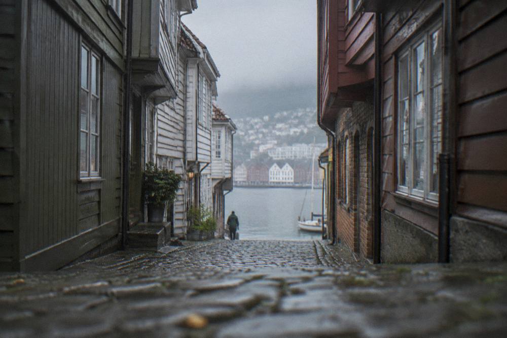 Narrow alley between tall wooden buildings in the historic wharf district