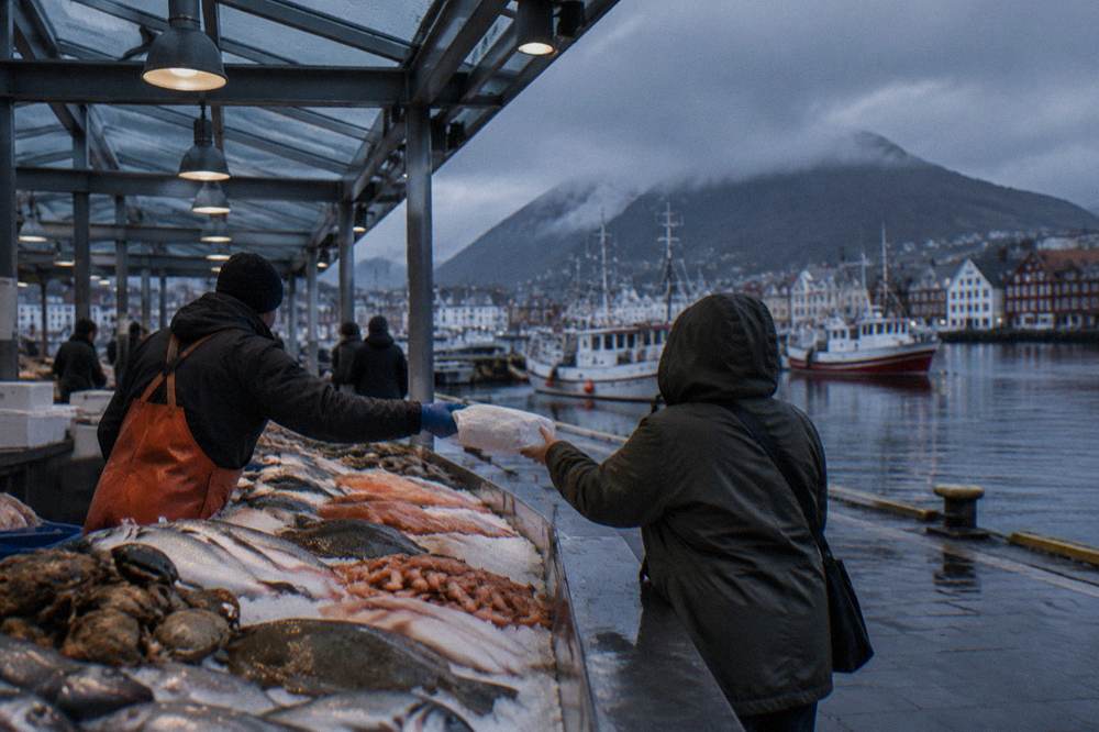 A fishmonger handing a wrapped fish parcel across an ice-filled display counter