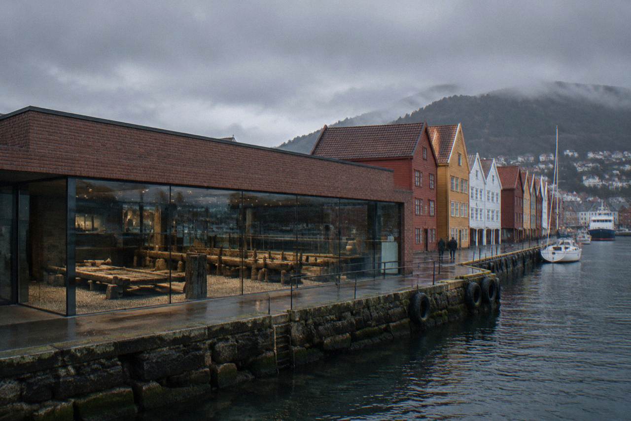 The modern museum building of Bryggens Museum beside the wooden gabled warehouses of Bryggen in Bergen