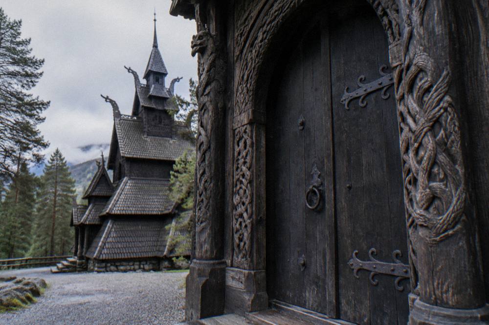 A close view of the church's carved wooden doorway with dark vertical planks and iron fittings