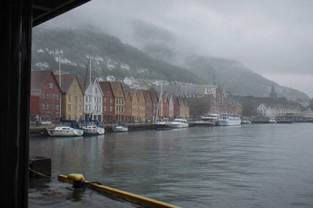 Row of colorful gabled wooden warehouses along the Bergen wharf on a cloudy day