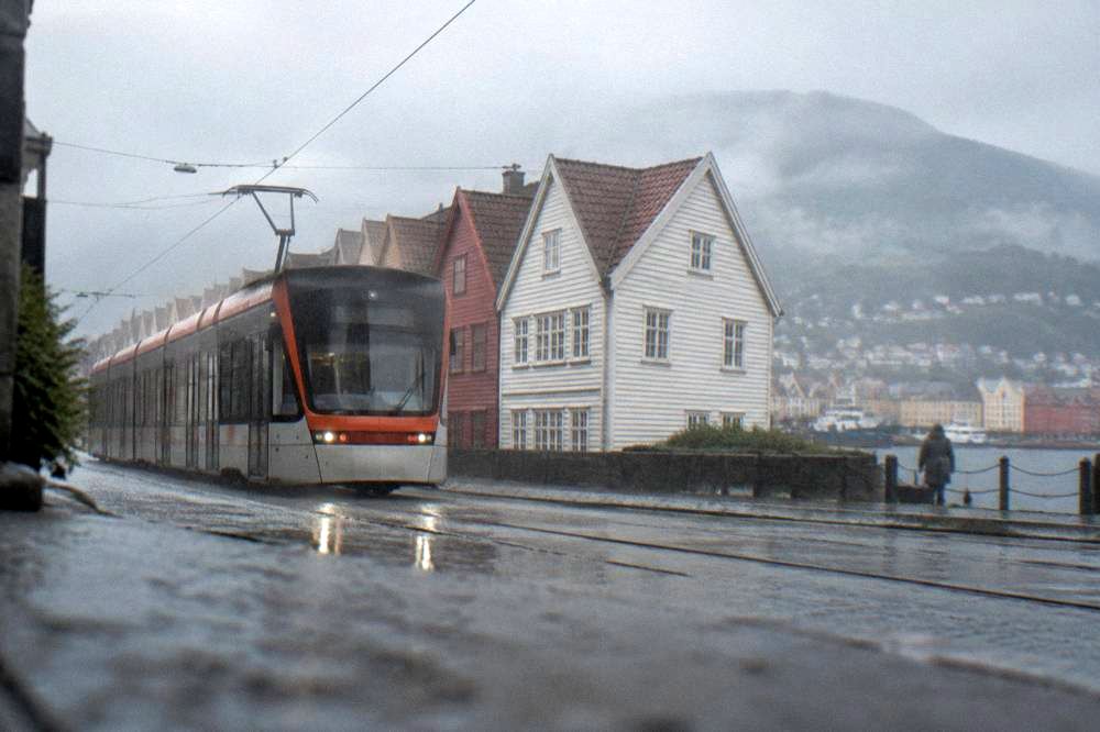 A light rail vehicle on a street in Bergen with wooden houses behind it