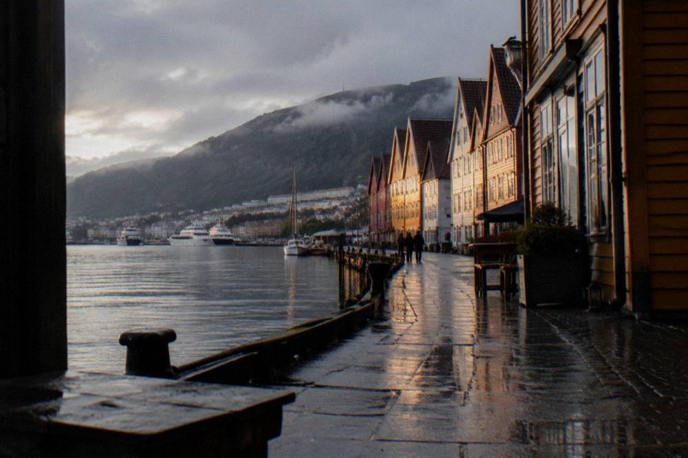 Evening light on wooden buildings along the Bergen waterfront near the old Hanseatic wharf