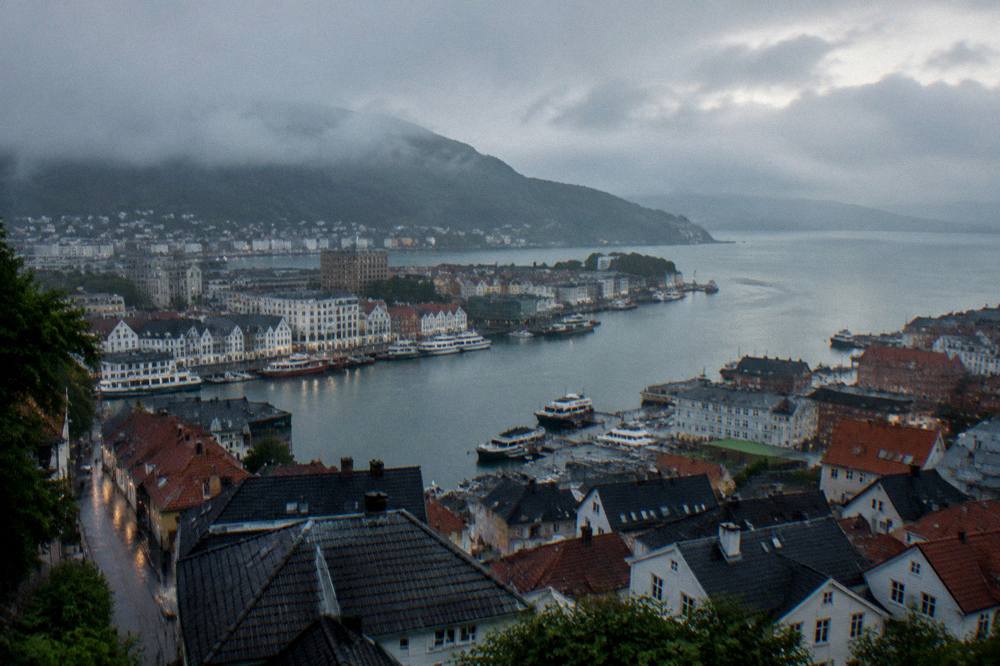Aerial view of Bergen city rooftops and harbour water at dusk