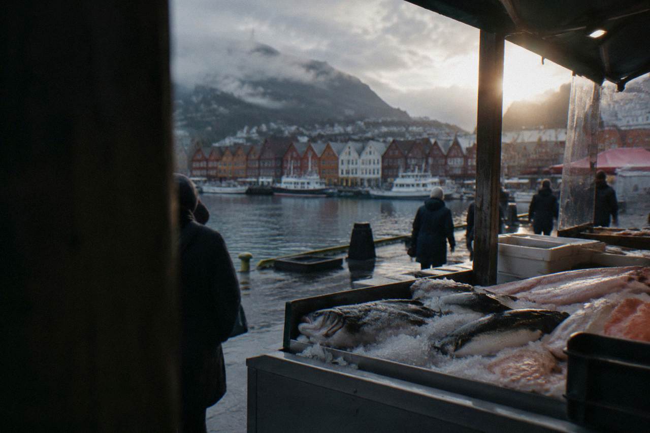Harbourside food stalls in Bergen with wooden buildings and a fish counter in the foreground