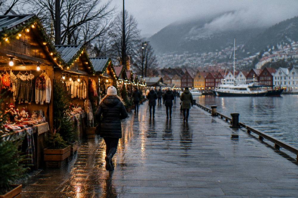 Wooden market stalls with warm string lights on a dark December evening at a Christmas market in Bergen