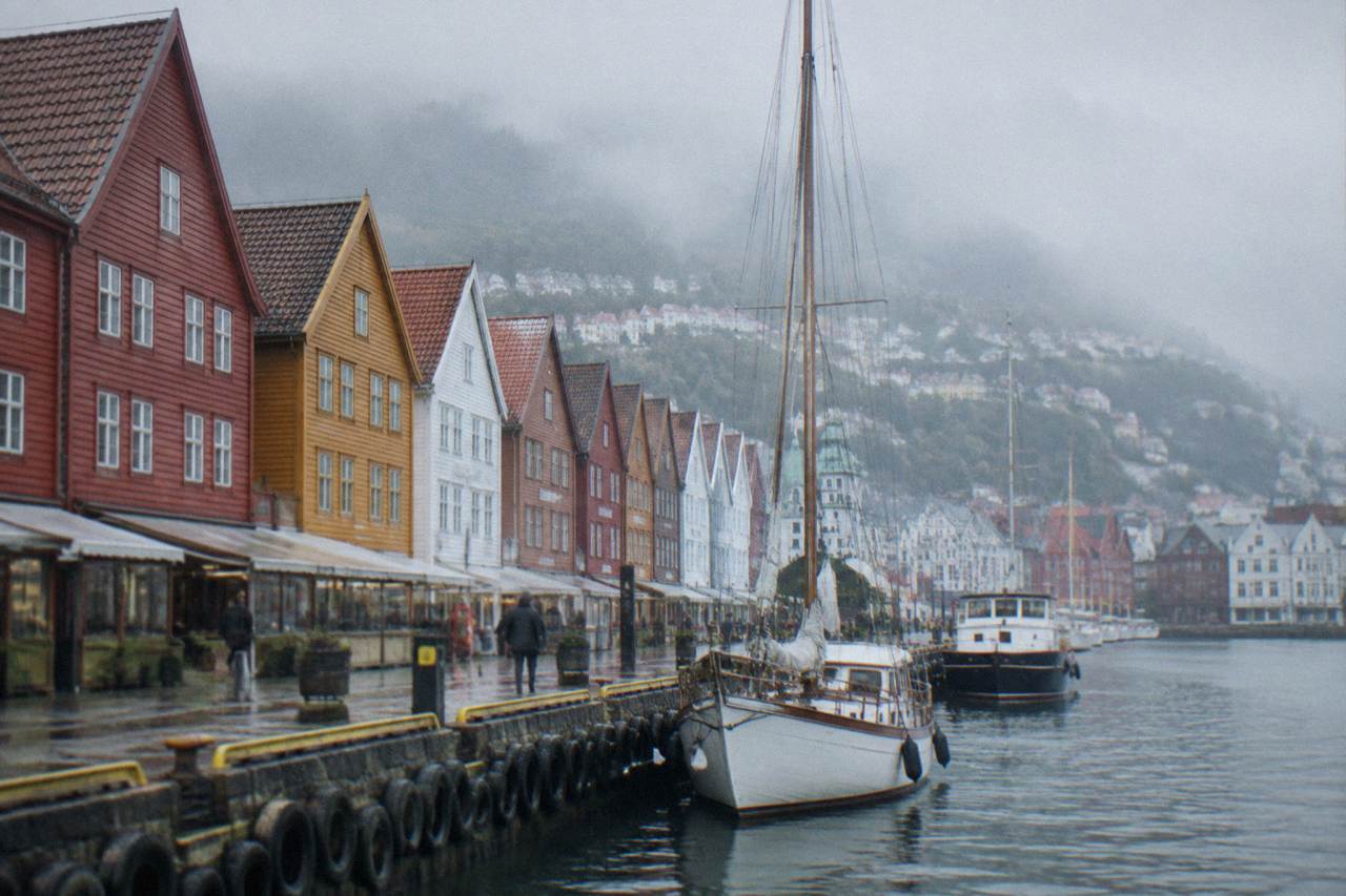 Colourful historic wooden buildings along the Hanseatic wharf in Bergen on an overcast day