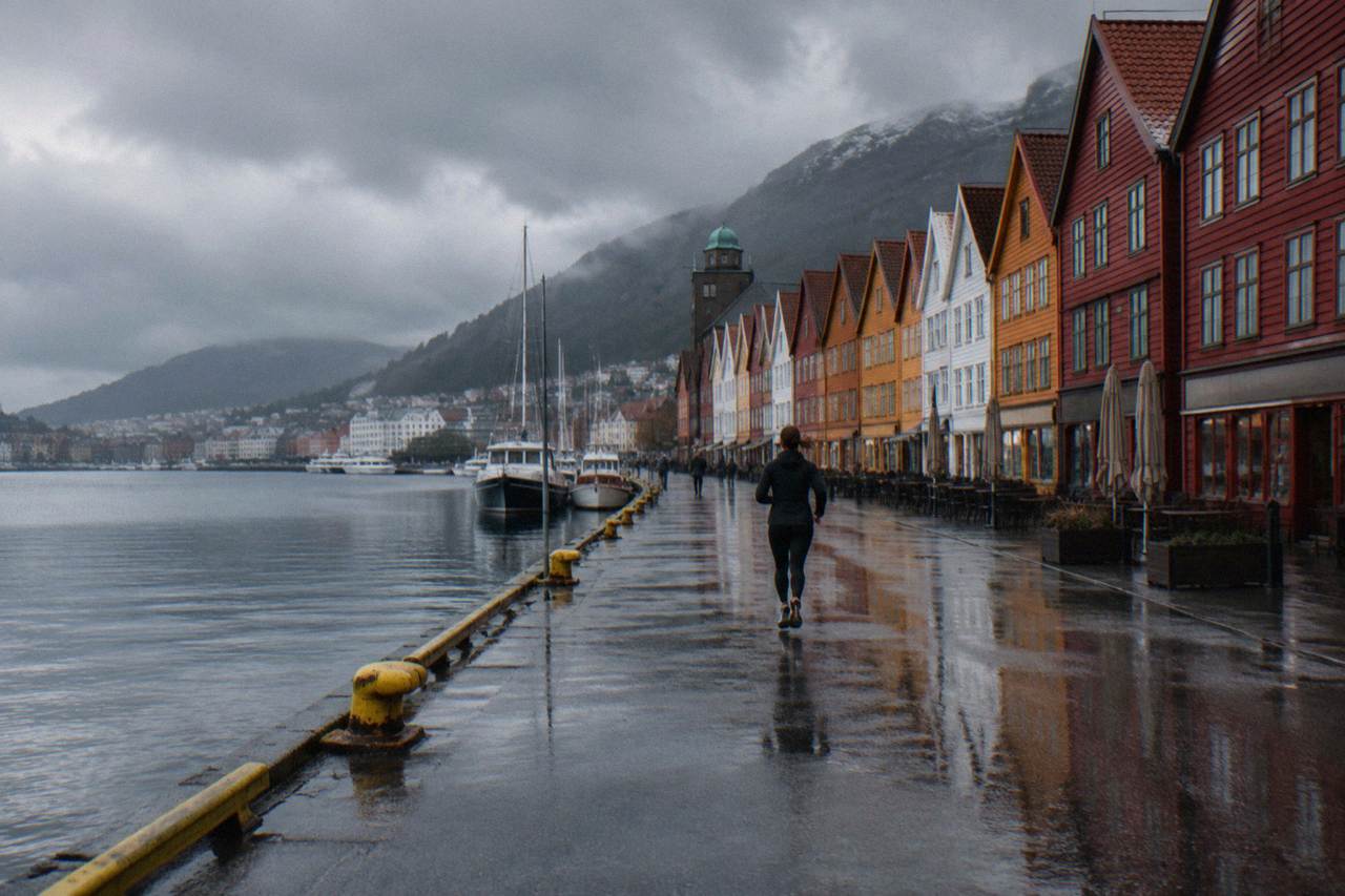Rain clouds hanging over the colourful Hanseatic wharf buildings along the Bergen harbour front
