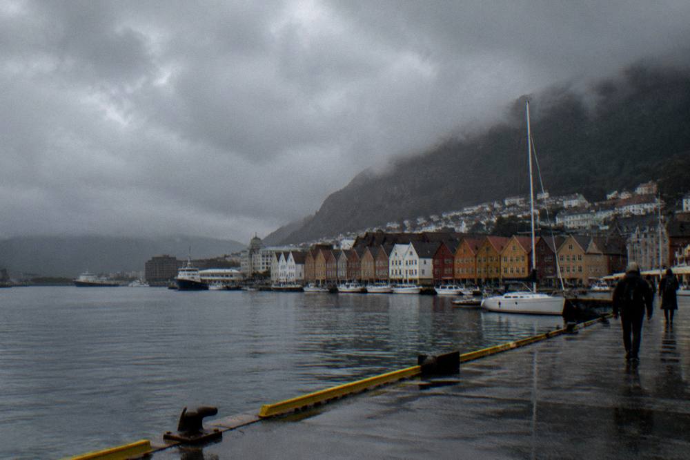 Rain clouds moving across the Bergen skyline with dark weather over the harbour and city rooftops
