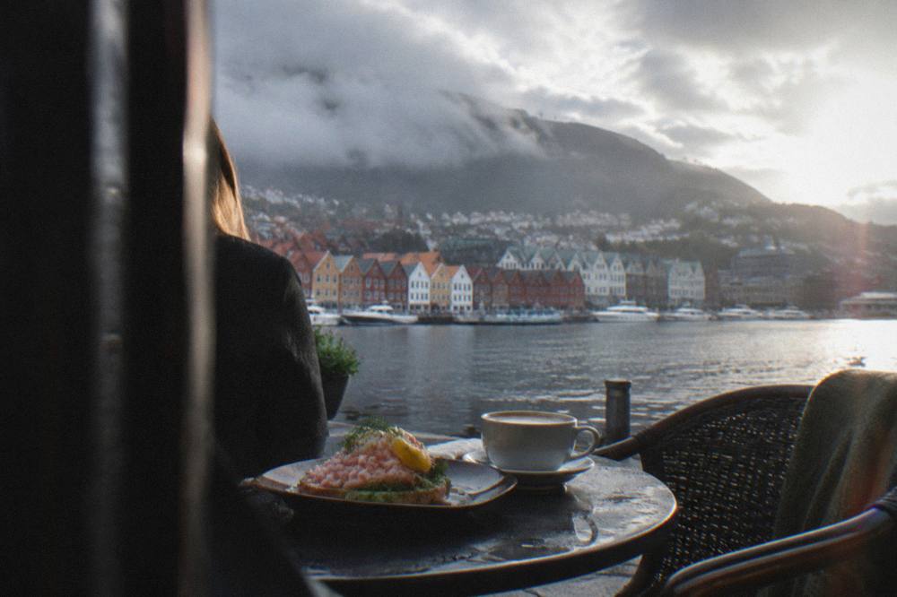 Coffee and an open-faced shrimp sandwich on a café table in Bergen