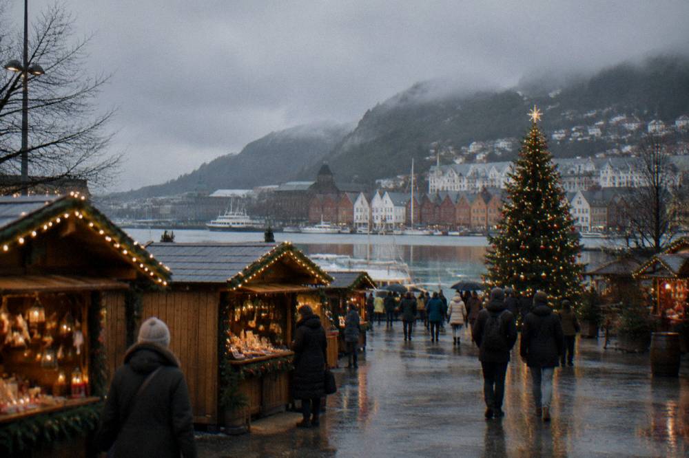 Wooden Christmas market stalls with string lights and a decorated tree at Festplassen in Bergen