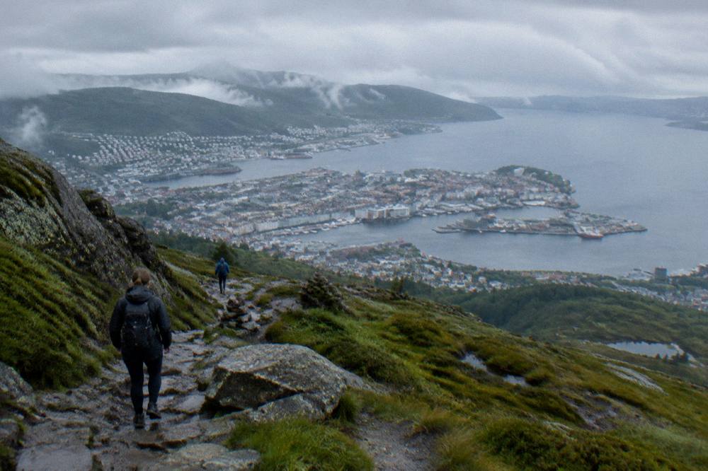 Rocky trail leading toward the Ulriken summit with the city visible far below
