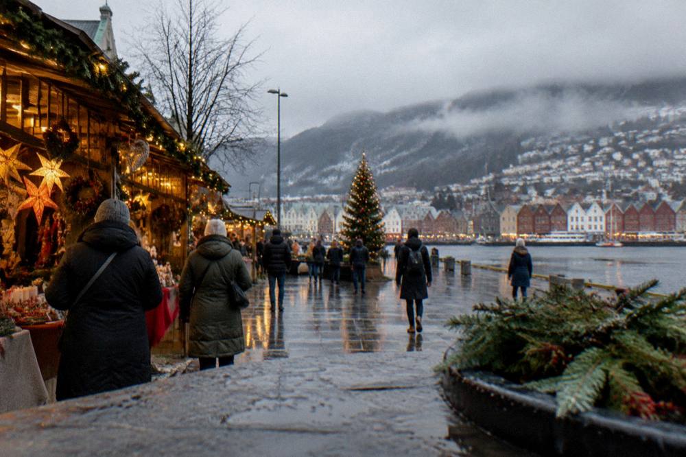 A Christmas market with decorated stalls and lights beside a lake in a Norwegian city square