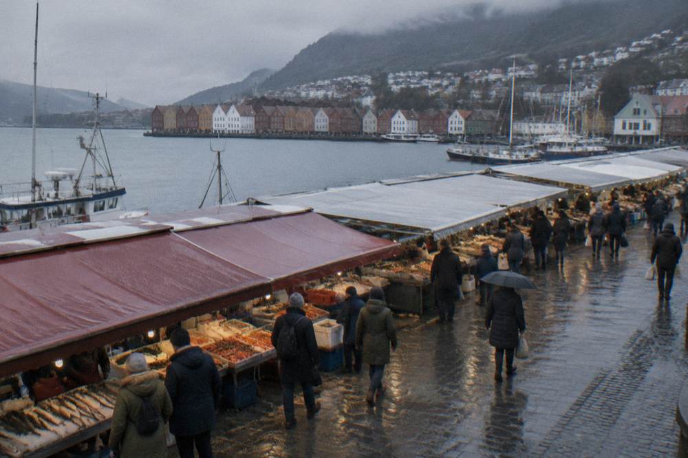 Visitors browsing stalls under the awnings of Bergen's harbourside fish market