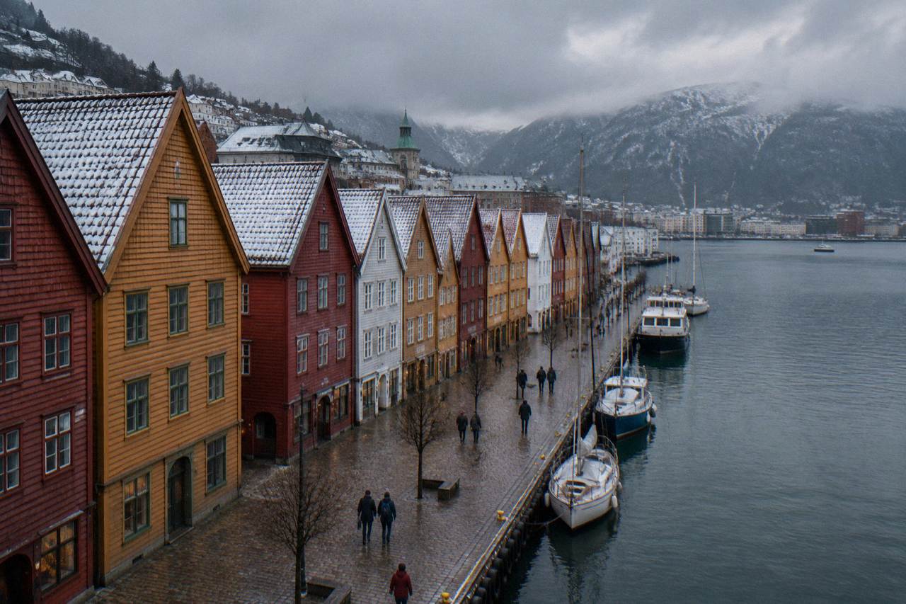 Colorful wooden Hanseatic buildings at Bryggen in Bergen dusted with light winter snow
