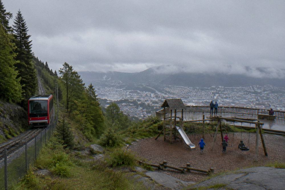 Children playing on a wooden playground on the Fløyen mountain plateau above Bergen