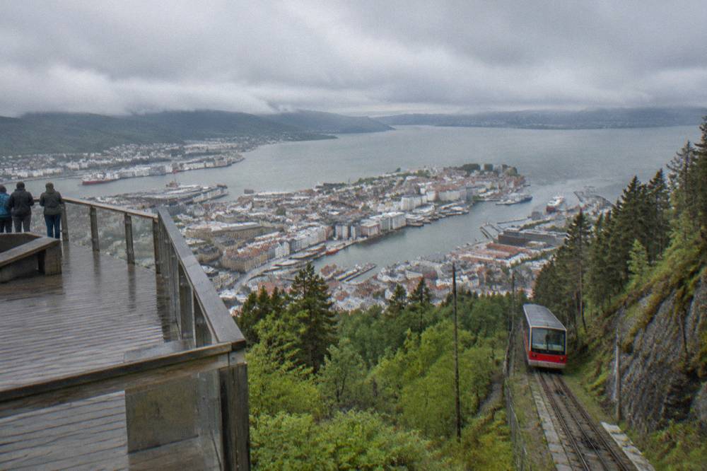 View from Mount Fløyen looking down over the red and white roofs of central Bergen and the harbour