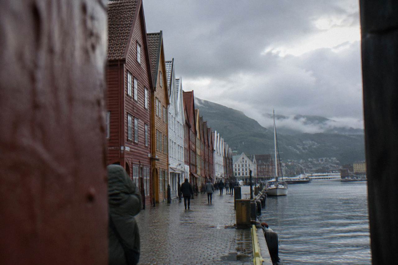 Colourful wooden warehouses of Bryggen wharf standing along Bergen harbour on an overcast day